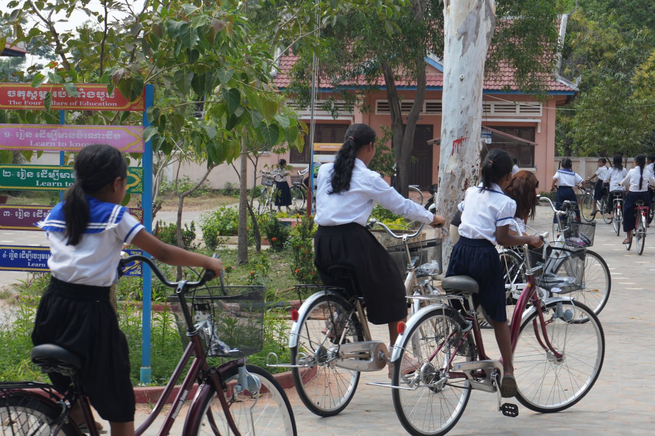 Students riding their new bicycles to school